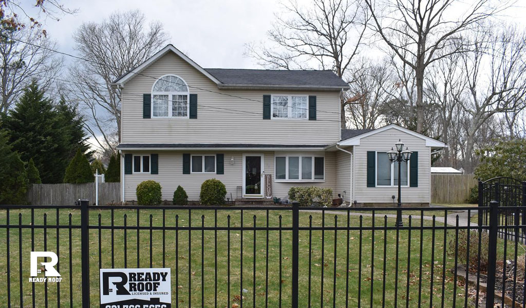 completed home exterior with a Ready Roof yard sign, showing value for your gutter installation cost on long island.