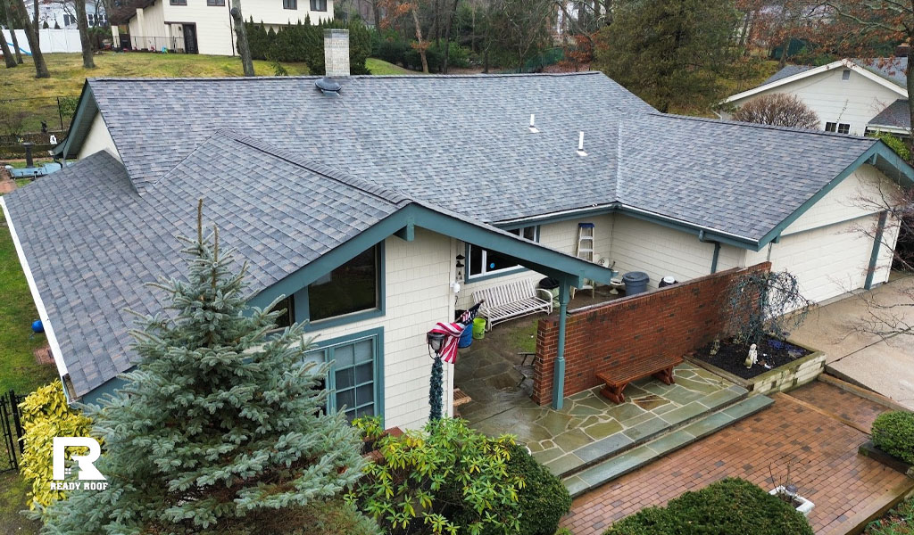 High-angle view of a residential home with fresh shingles and clean trim following a successful roof fascia repair.