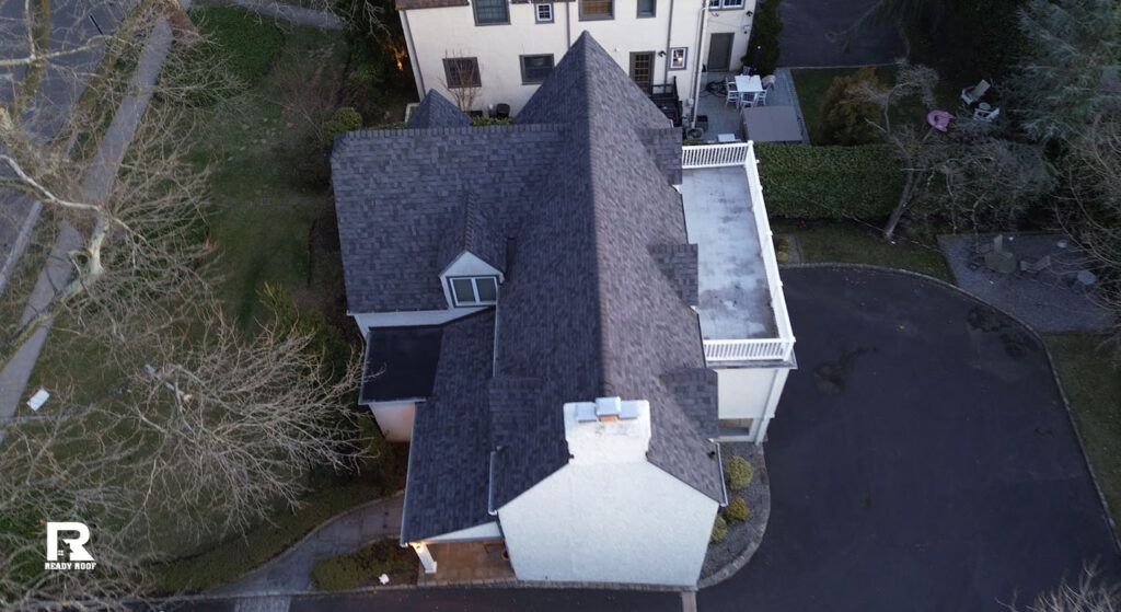 Aerial shot of a high-end home after deciding between roof repair vs roof replacement services.
