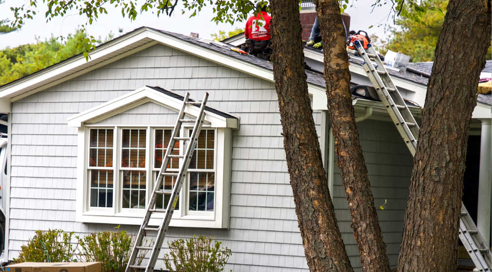 cleaning gutters to prevent roof leaks