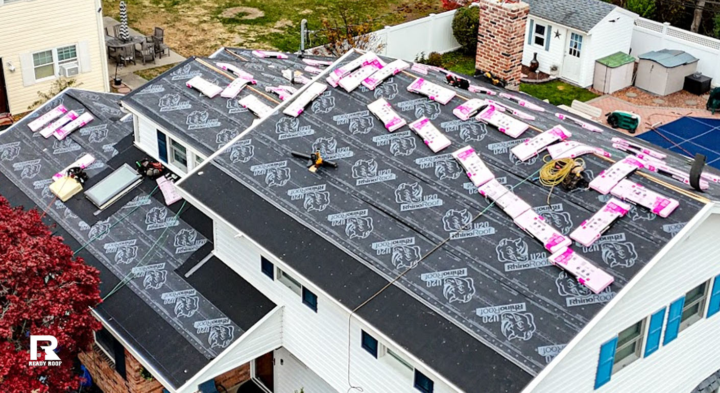 Aerial view of a residential roof covered in underlayment, showing factors affecting roof repair cost on Long Island.