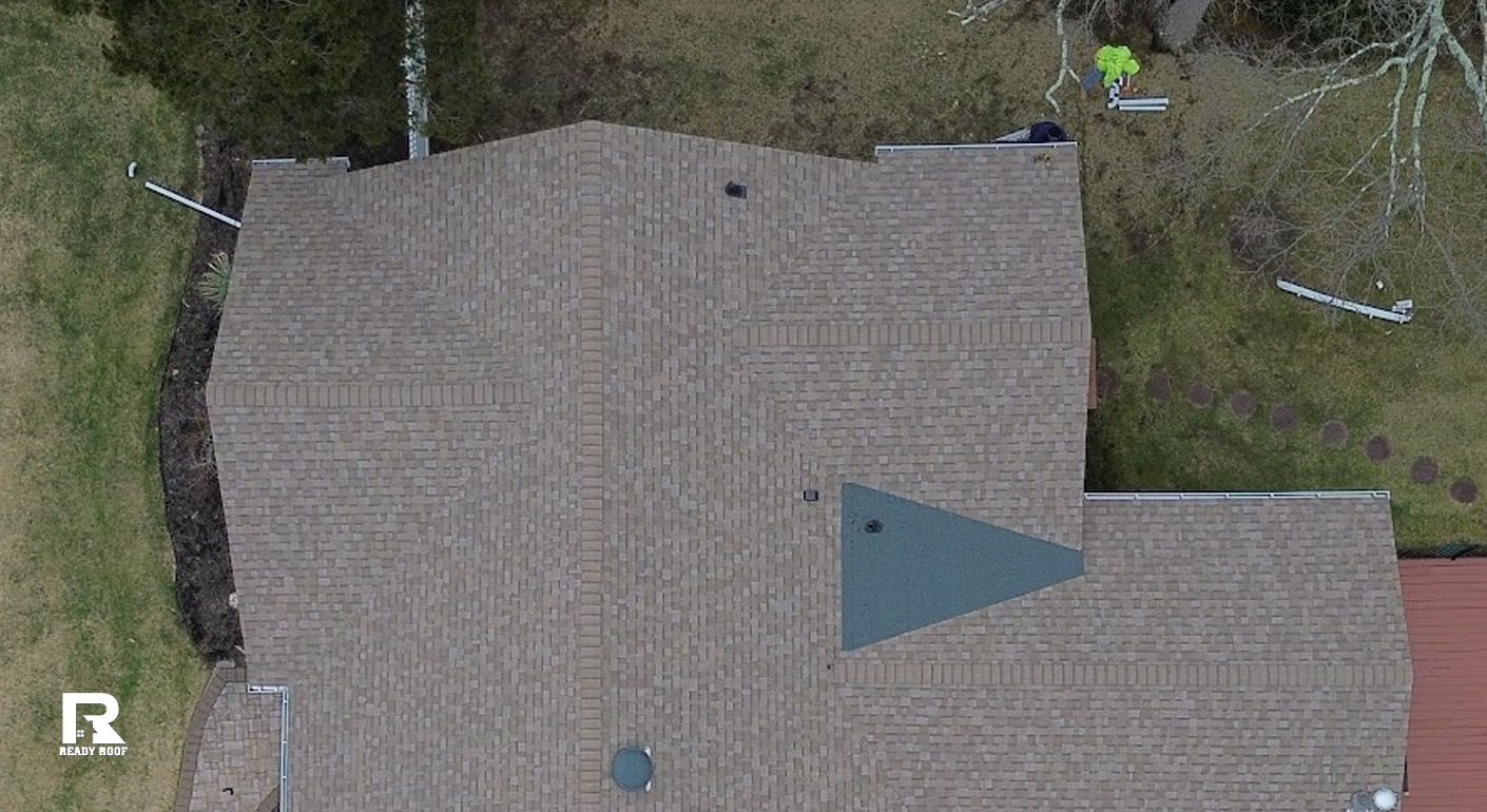 Aerial perspective of a complex residential roof structure, highlighting the best roofing materials long island homeowners choose for lasting durability.